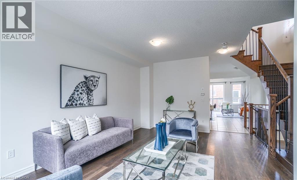 Main living area featuring dark wood-finish flooring, white walls, and recessed lighting - 14 Faye Street, Brampton, ON - Indoor Photo Showing Living Room