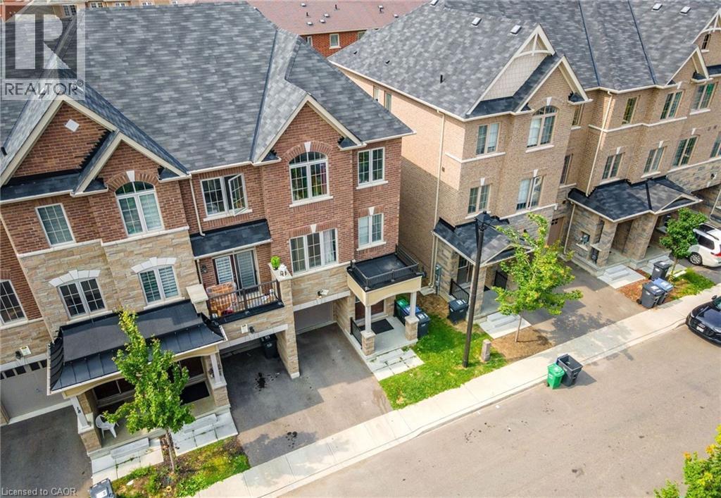 Brick and stone-clad townhomes featuring architectural shingles, covered entryways, and integral garages - 14 Faye Street, Brampton, ON - Outdoor With Facade