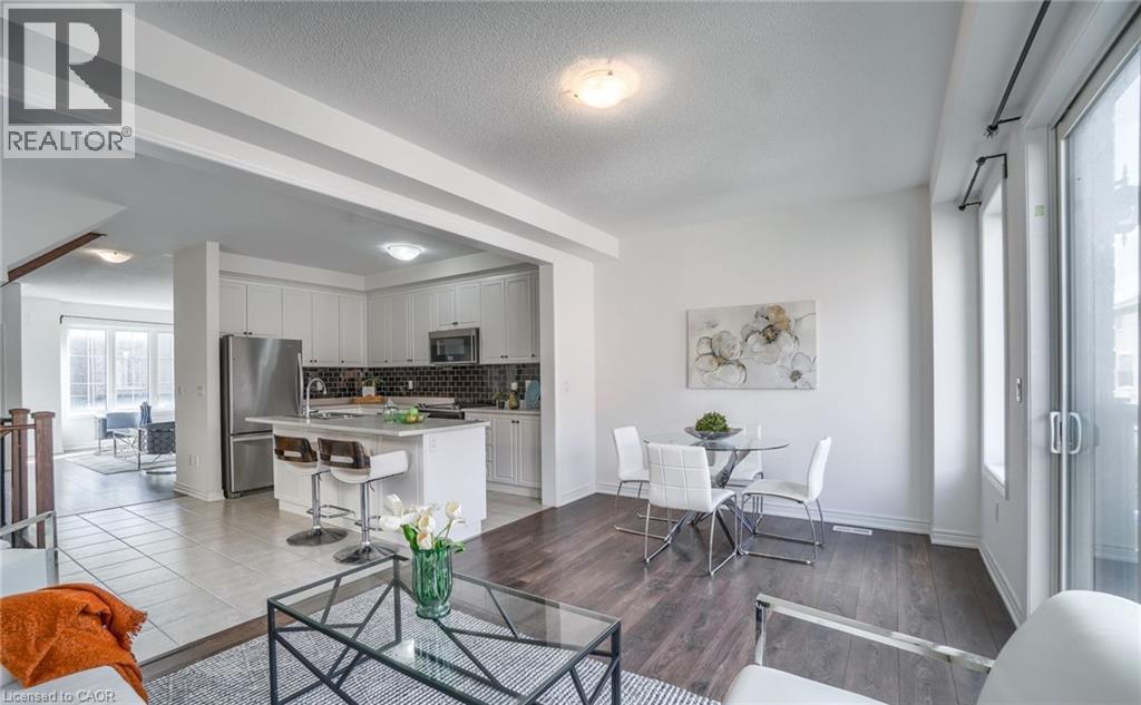 Open-concept living area featuring dark wood-finish flooring, white walls, and recessed lighting - 14 Faye Street, Brampton, ON - Indoor