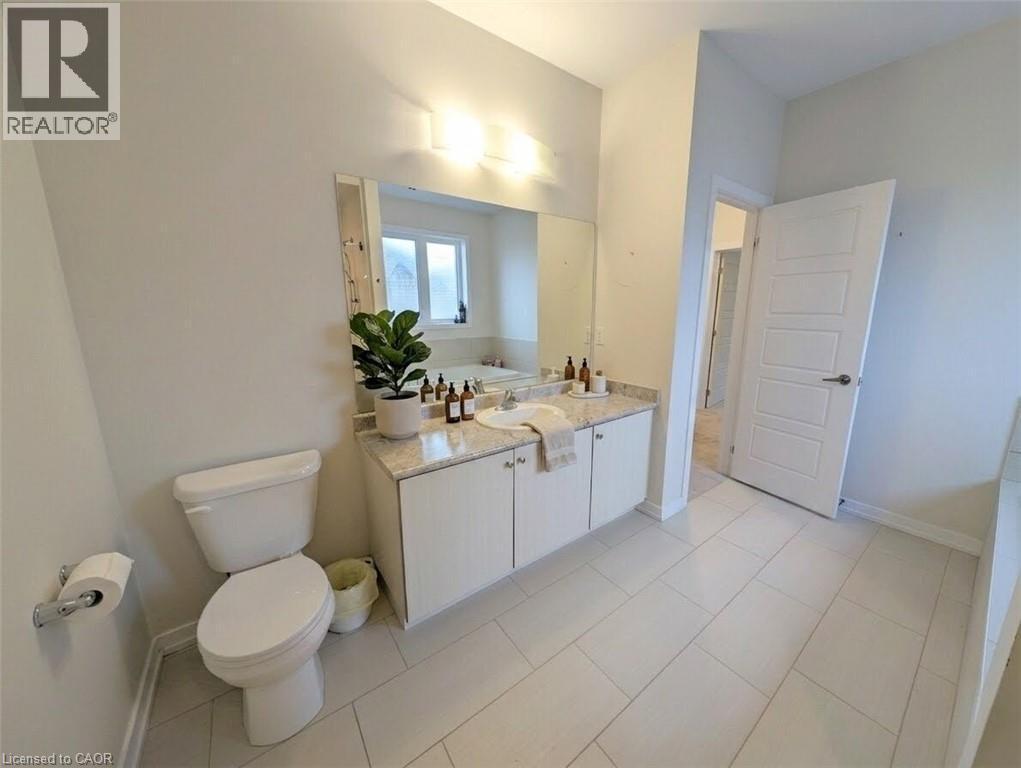 Bathroom featuring a single vanity with stone countertop, white cabinetry, and an integrated rectangular sink - 37 Mull Avenue, Caledonia, ON - Indoor Photo Showing Bathroom