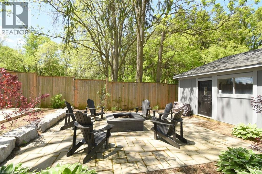 Expansive paver patio featuring a built-in fire pit - 89 Lynden Road, Lynden, ON