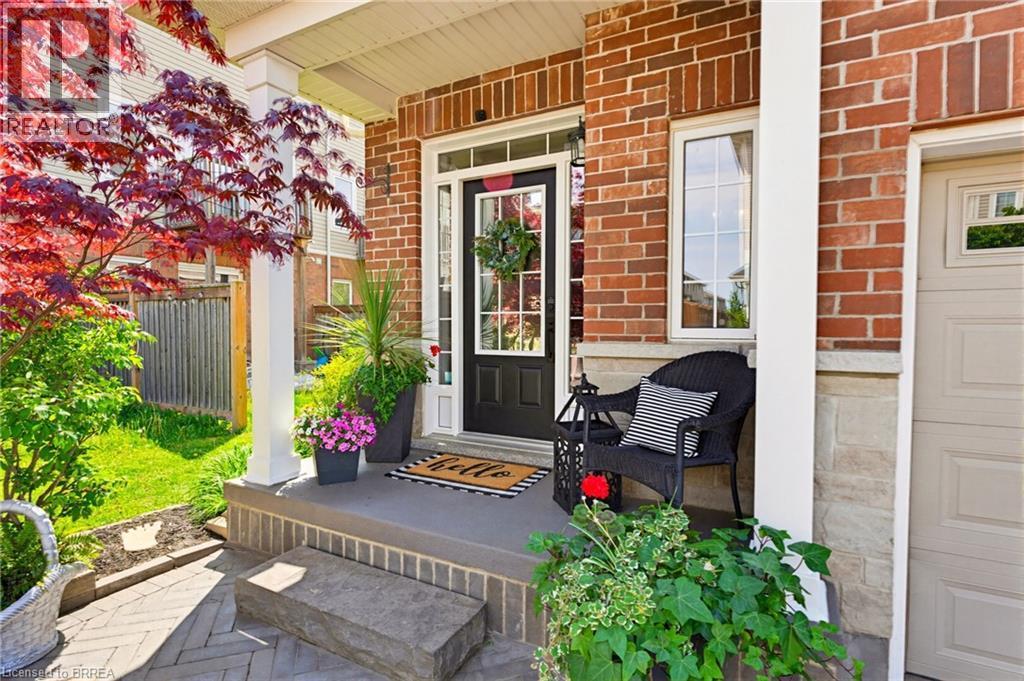 Brick and stone facade featuring a portico entry with white columns - 100 Chester Drive Unit# 16, Cambridge, ON - Outdoor With Exterior