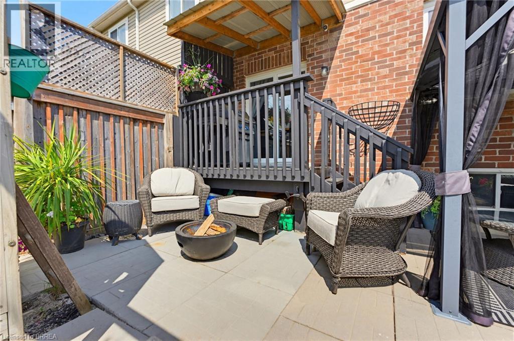 Private backyard patio with concrete pavers and a wood privacy fence - 100 Chester Drive Unit# 16, Cambridge, ON - Outdoor With Deck Patio Veranda With Exterior