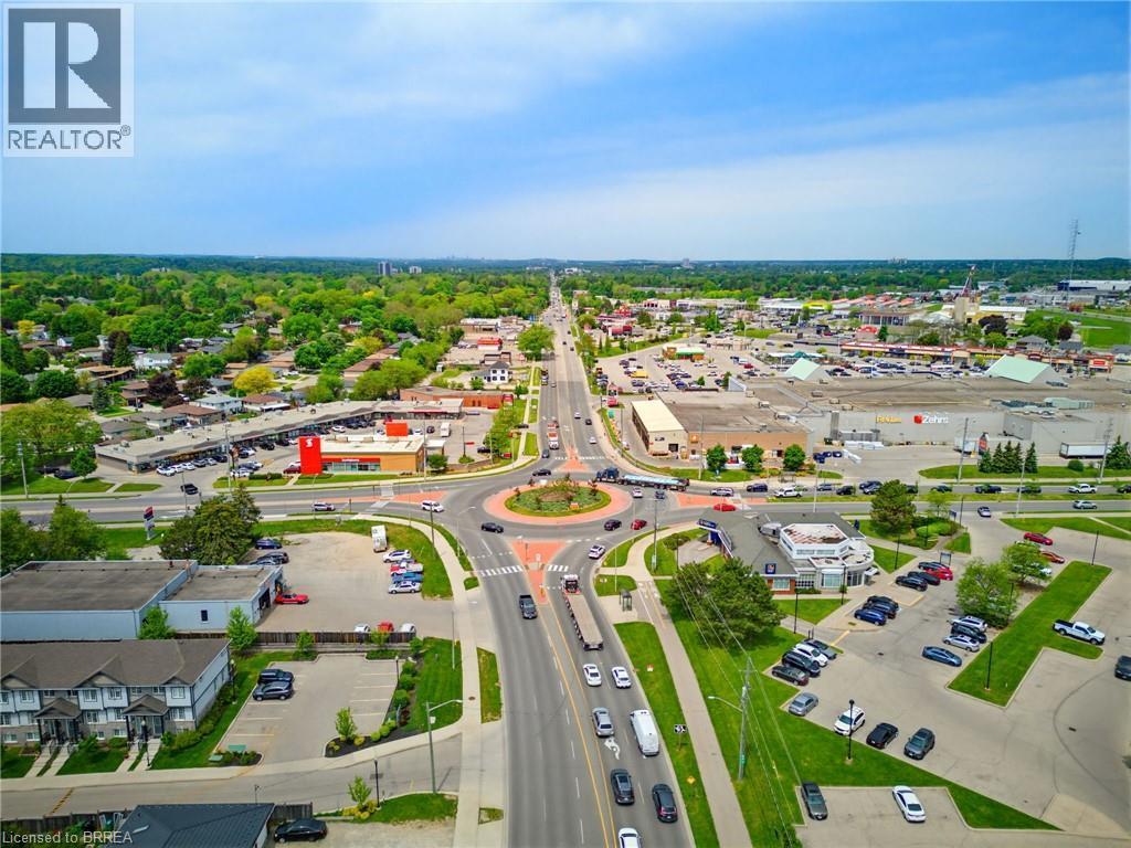 Aerial perspective showcasing a multi-lane road network with a central roundabout - 100 Chester Drive Unit# 16, Cambridge, ON - Outdoor With View