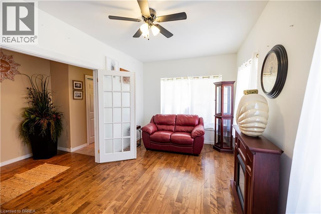 Hardwood-finish flooring throughout, featuring a ceiling fan with integrated lighting - 100 Mechanic Street W, Waterford, ON - Indoor