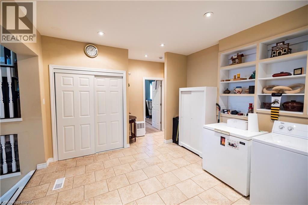Utility area featuring built-in shelving, recessed lighting, and neutral-toned wall paint - 100 Mechanic Street W, Waterford, ON - Indoor Photo Showing Laundry Room