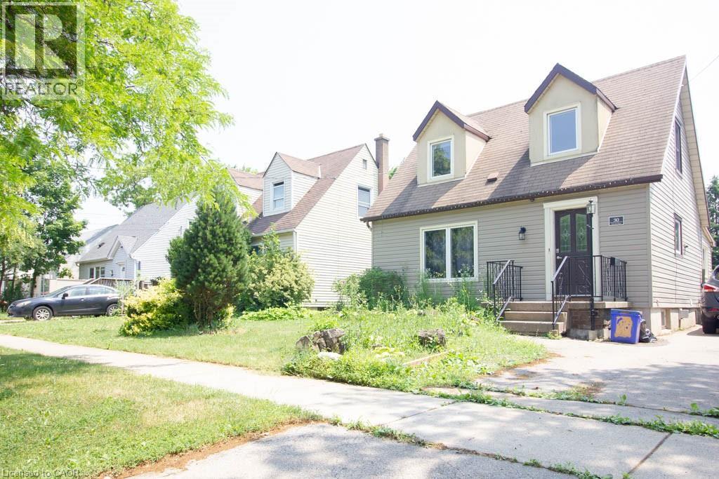 Gable-roof property featuring dormer windows, a front entry with double doors, and exterior lighting - 30 Eastvale Place, Hamilton, ON - Outdoor