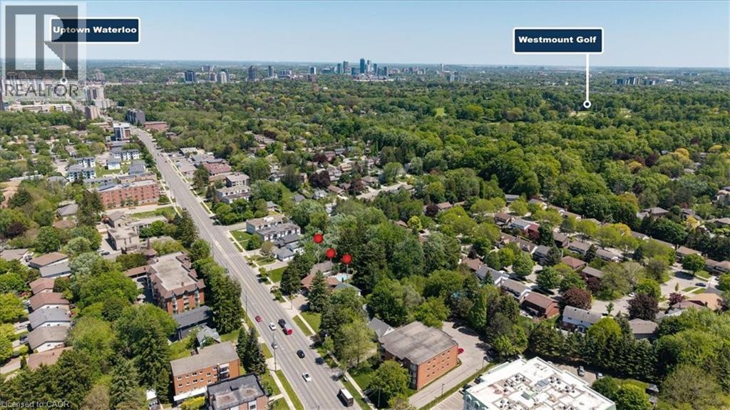 Aerial perspective showcasing a residential area with extensive tree coverage - 391 Erb Street, Waterloo, ON