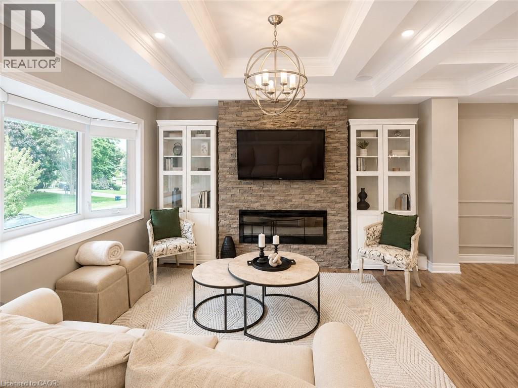 Coffered ceiling with recessed lighting and a central spherical chandelier - 107 Rosslinn Road, Cambridge, ON - Indoor Photo Showing Living Room With Fireplace