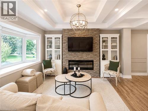Coffered ceiling with recessed lighting and a central spherical chandelier - 107 Rosslinn Road, Cambridge, ON - Indoor Photo Showing Living Room With Fireplace