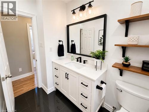 Bathroom featuring a white vanity with black hardware, a black-framed mirror, and a three-light vanity fixture - 107 Rosslinn Road, Cambridge, ON - Indoor Photo Showing Bathroom