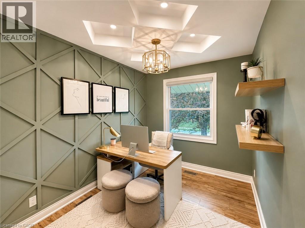 Accent wall with geometric trim, tray ceiling with recessed lighting, and a decorative chandelier - 107 Rosslinn Road, Cambridge, ON - Indoor