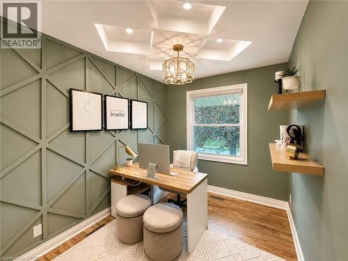Accent wall with geometric trim, tray ceiling with recessed lighting, and a decorative chandelier - 107 Rosslinn Road, Cambridge, ON - Indoor