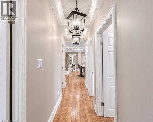 Hallway featuring wood-finish flooring, light neutral wall tones, and white baseboards - 107 Rosslinn Road, Cambridge, ON - Indoor Photo Showing Other Room