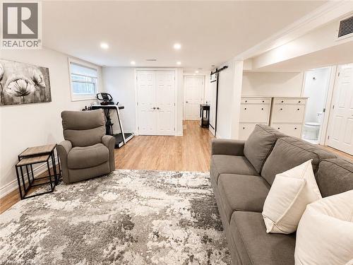 Finished lower level featuring recessed lighting, wood-finish flooring, and white trim - 107 Rosslinn Road, Cambridge, ON - Indoor Photo Showing Living Room