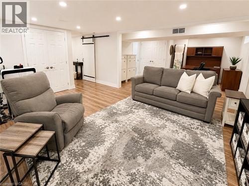 Spacious room featuring wood-finish flooring, recessed lighting, and white baseboards - 107 Rosslinn Road, Cambridge, ON - Indoor Photo Showing Living Room