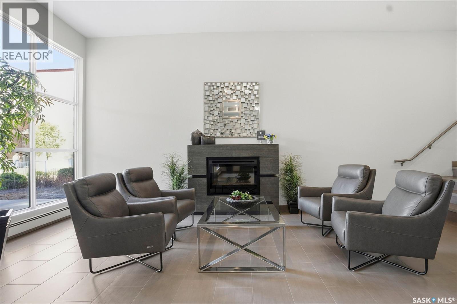 303 1025 Moss Avenue, Saskatoon, SK - Indoor Photo Showing Living Room With Fireplace