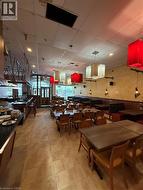 Spacious interior featuring neutral-toned tile flooring, recessed ceiling lighting, and a variety of decorative pendant light fixtures -