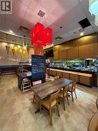 Ceramic tile flooring, drop ceiling with recessed lighting, and integrated buffet counter -