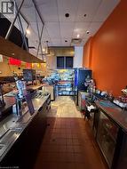 Commercial kitchen and service area featuring multiple stainless steel workstations -