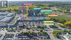 Aerial perspective of a commercial plaza featuring multiple retail and dining establishments -
