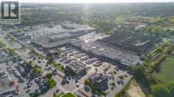 Aerial perspective showcasing a multi-building commercial complex with extensive surface parking -