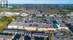 Aerial overview showcasing extensive commercial developments and residential properties -