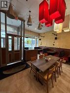 Commercial space featuring a prominent entrance with glass doors, tiled flooring, and multiple ceiling-mounted light fixtures -