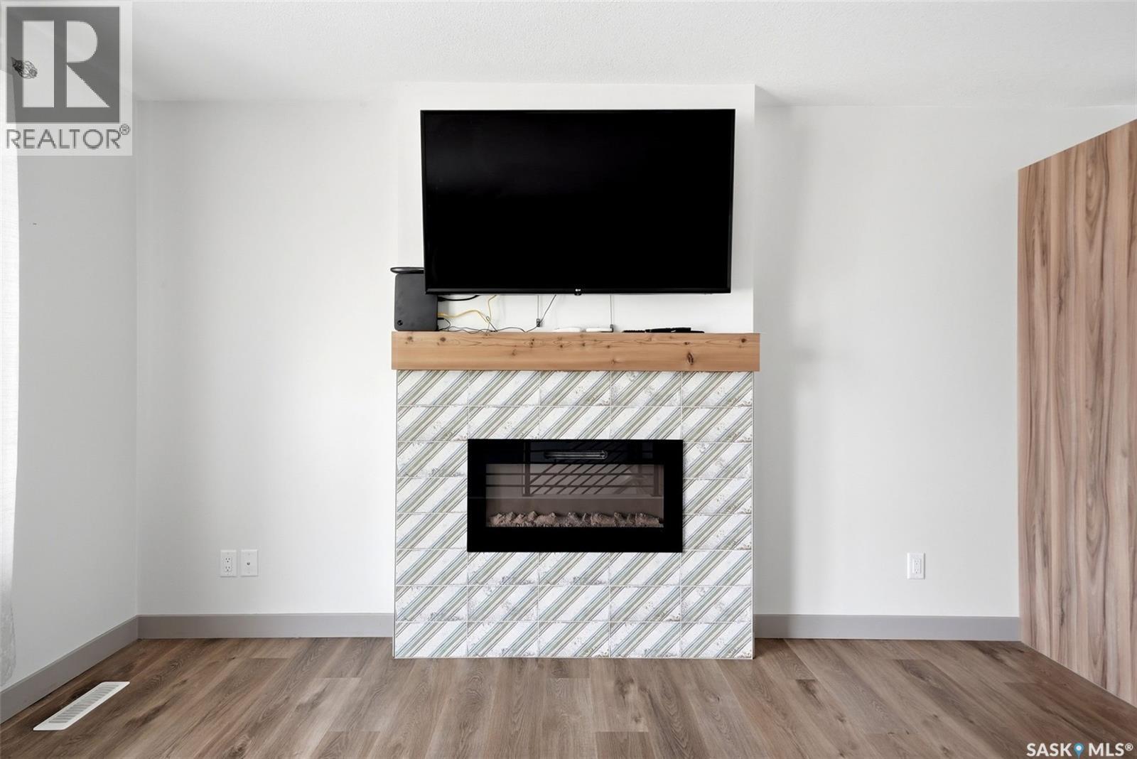 306 Howe Place, Regina, SK - Indoor Photo Showing Living Room With Fireplace