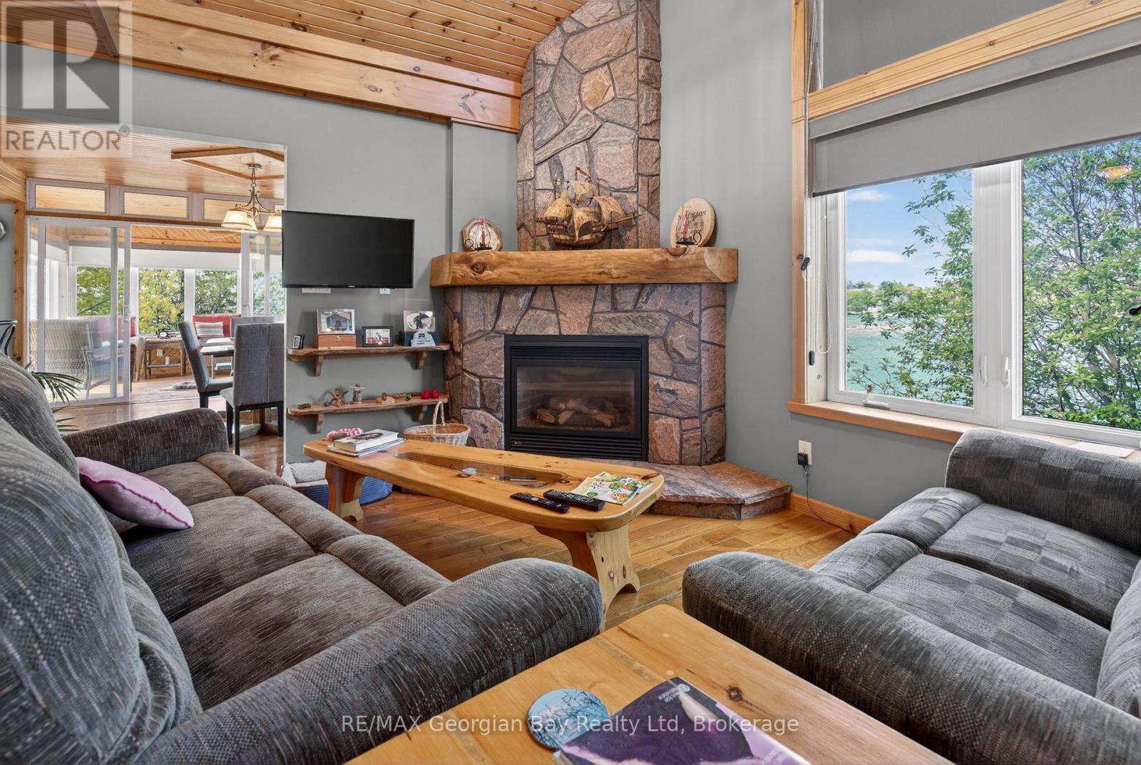 185 Picnic Island Road, Georgian Bay (Baxter), ON - Indoor Photo Showing Living Room With Fireplace