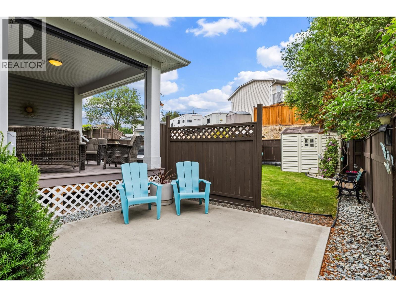 Concrete Patio and Walkways to Backyard Green Space - 827 Juniper Road, Kelowna, BC - Outdoor With Deck Patio Veranda With Exterior