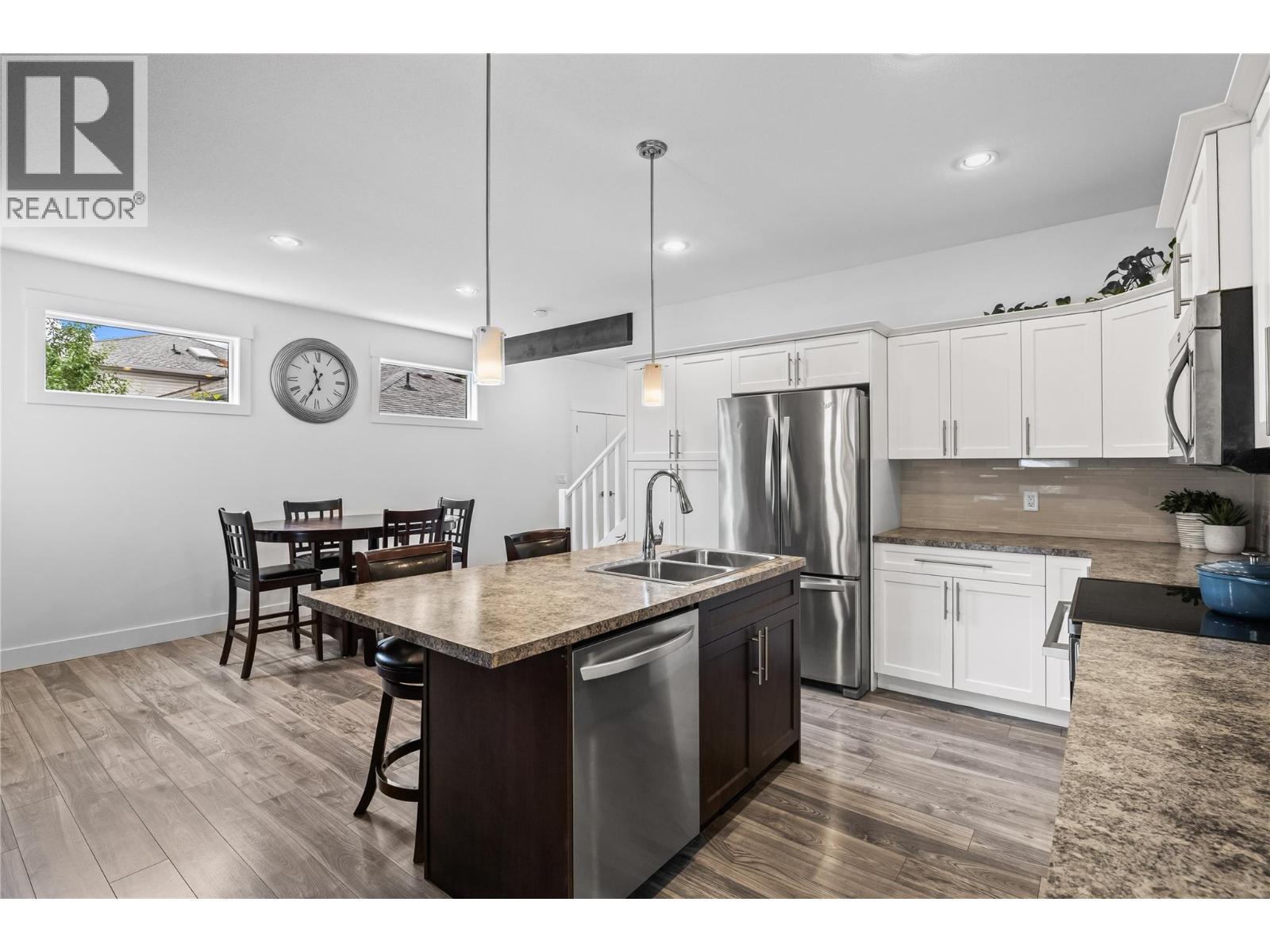Open Dining with Island Seating and Dining Space - 827 Juniper Road, Kelowna, BC - Indoor Photo Showing Kitchen With Double Sink With Upgraded Kitchen