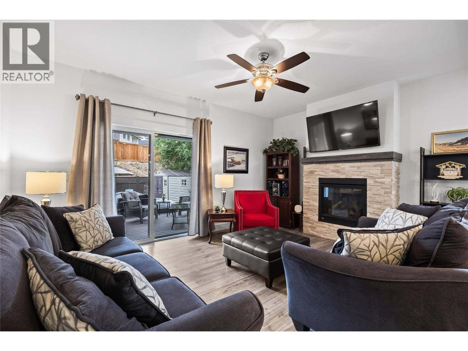Great-Room with Split Quartz Gas Fireplace Surround - 827 Juniper Road, Kelowna, BC - Indoor Photo Showing Living Room With Fireplace