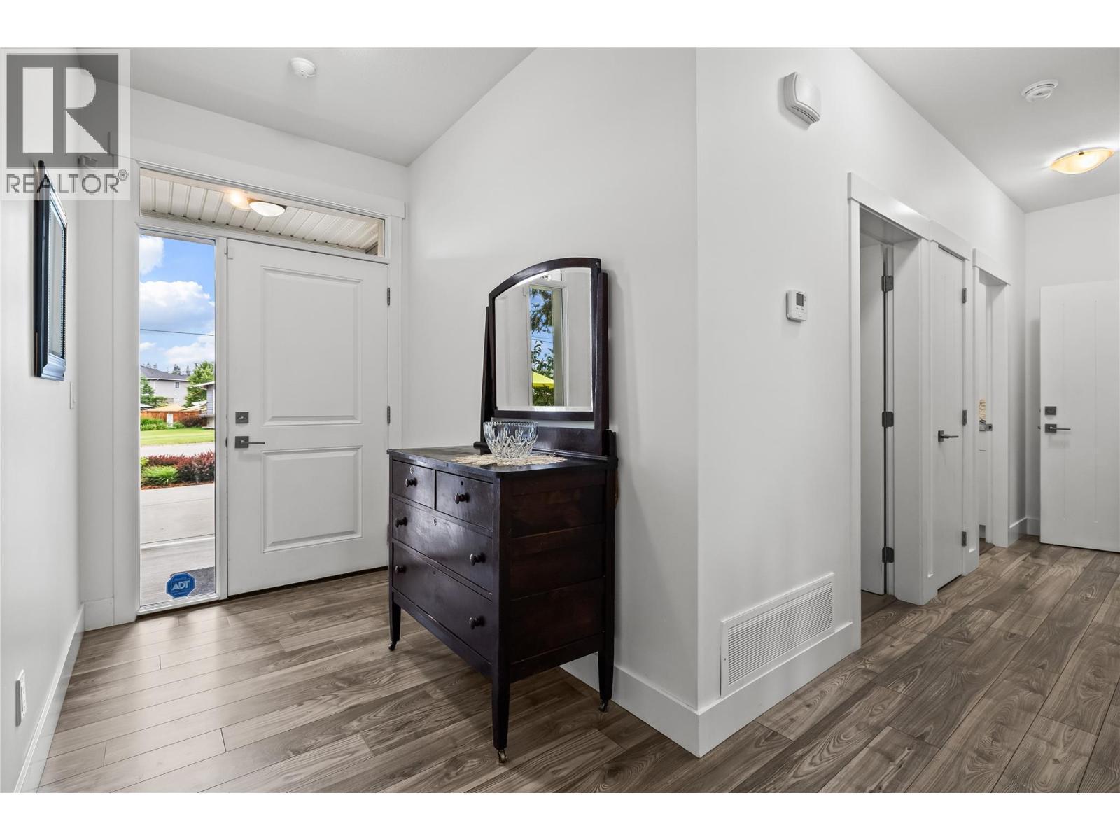 Spacious Entry Foyer with Large Closet - Hall to Mudroom and Powder Room - 827 Juniper Road, Kelowna, BC - Indoor Photo Showing Other Room