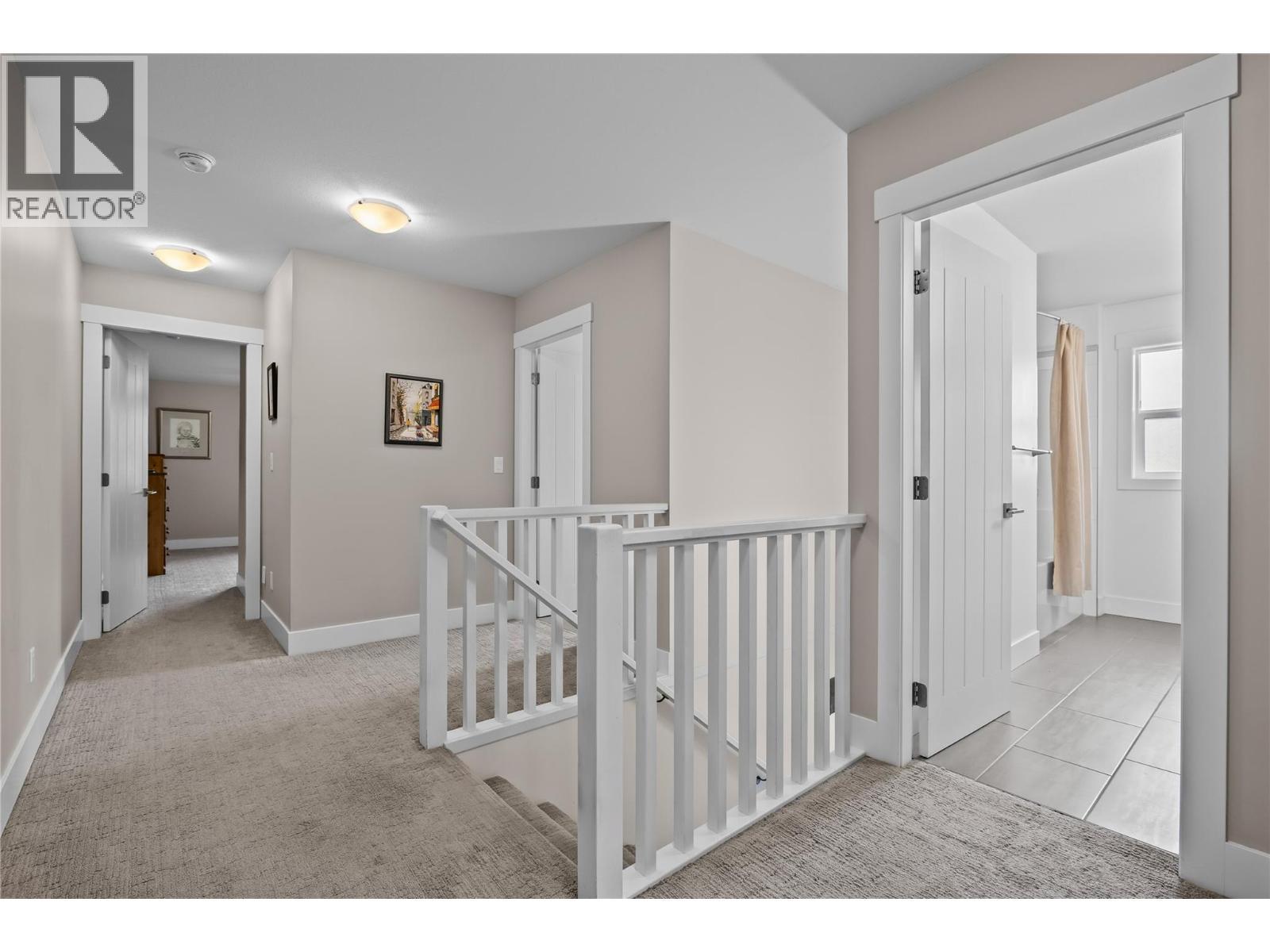 Spacious Halls to Upper Level Rooms - 827 Juniper Road, Kelowna, BC - Indoor Photo Showing Other Room