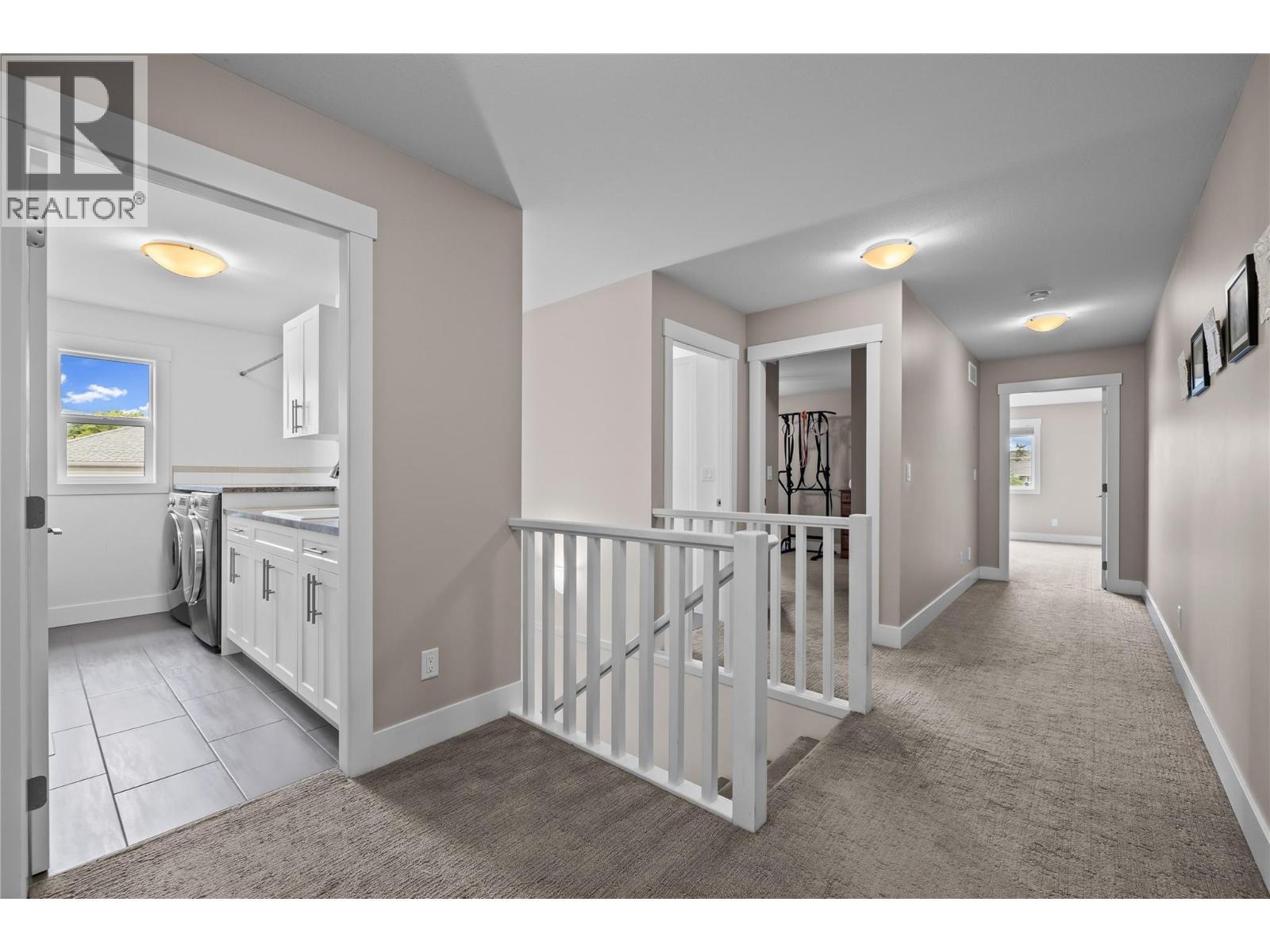 Spacious Halls to Upper Level Rooms - 827 Juniper Road, Kelowna, BC - Indoor Photo Showing Other Room