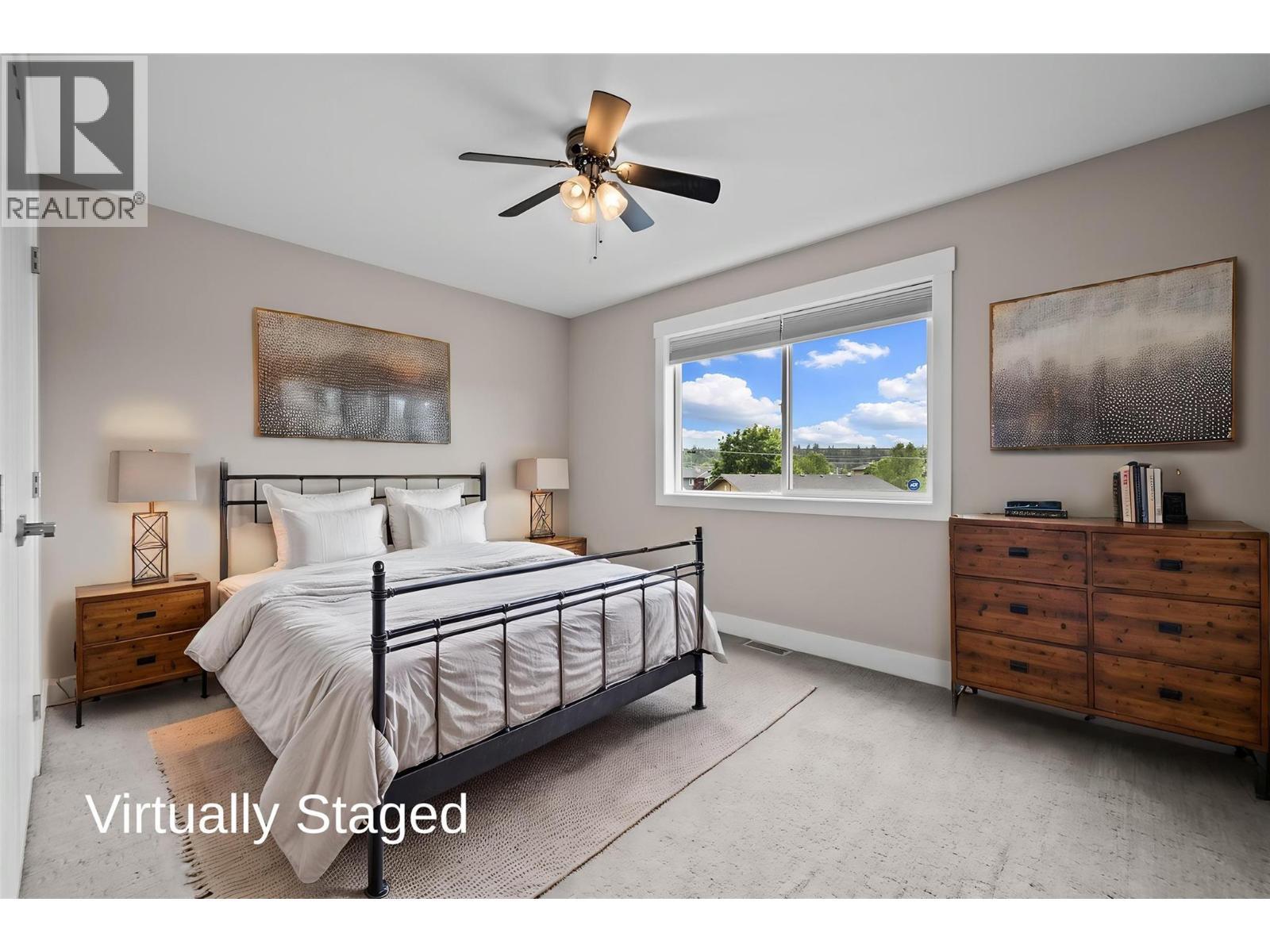 Virtually Staged - Large front Bedroom with Large Closet - 827 Juniper Road, Kelowna, BC - Indoor Photo Showing Bedroom