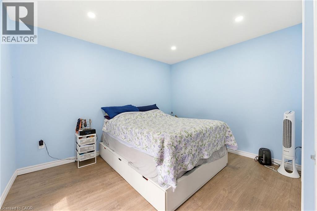 Spacious room featuring light blue walls and wood-finish flooring - 291 Park Avenue, Brantford, ON - Indoor Photo Showing Bedroom