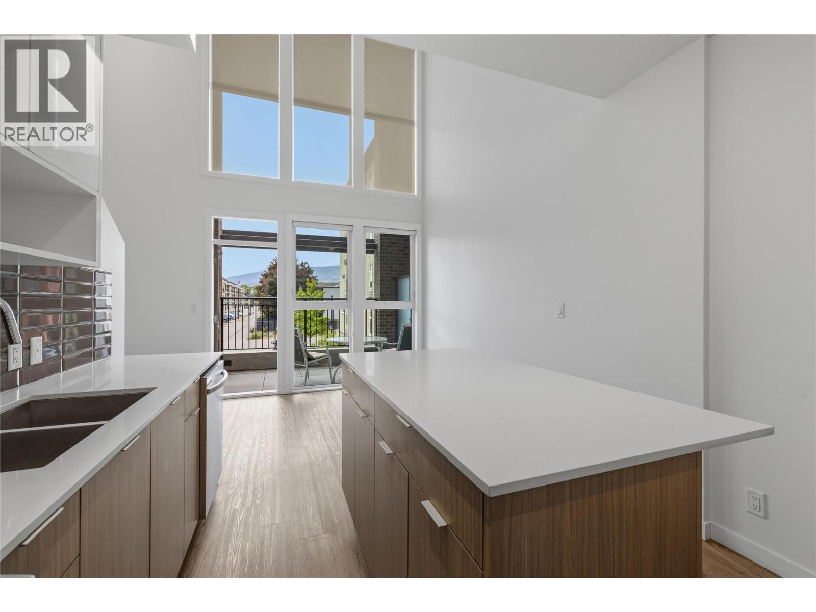 Open-concept design perfect for entertaining and everyday living. - 1775 Chapman Place Unit# 101, Kelowna, BC - Indoor Photo Showing Kitchen With Double Sink