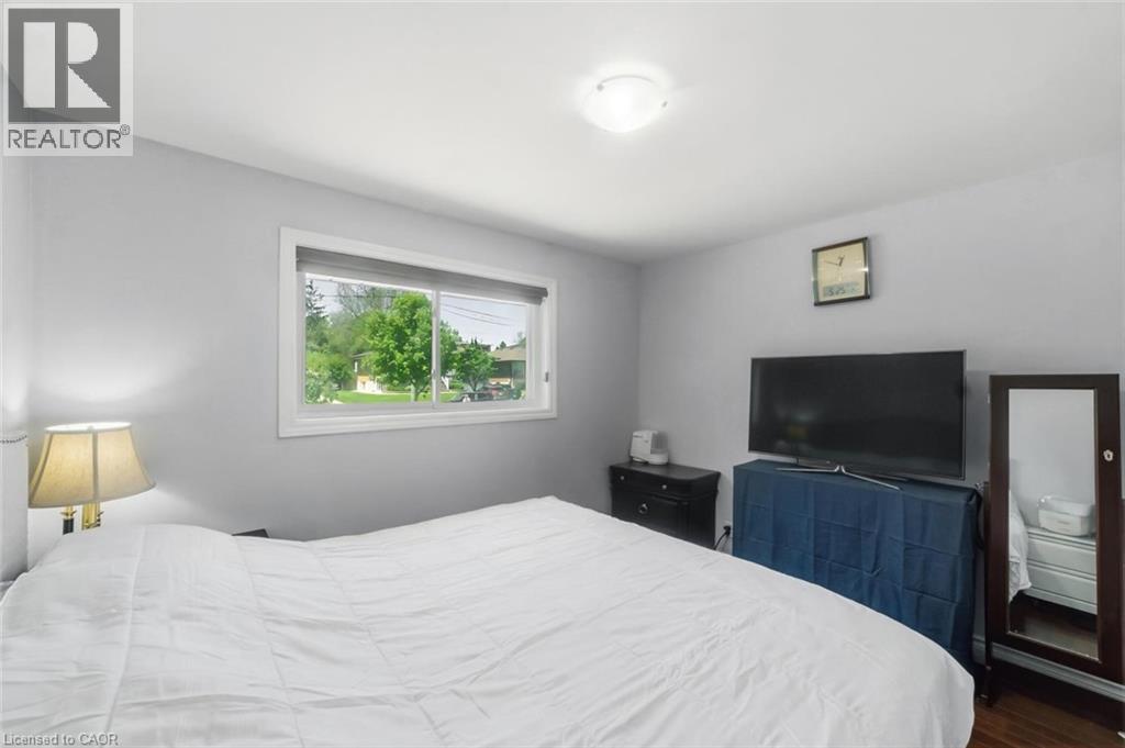 Light gray walls complementing wood-finish flooring - 158 Plymouth Road, Kitchener, ON - Indoor Photo Showing Bedroom