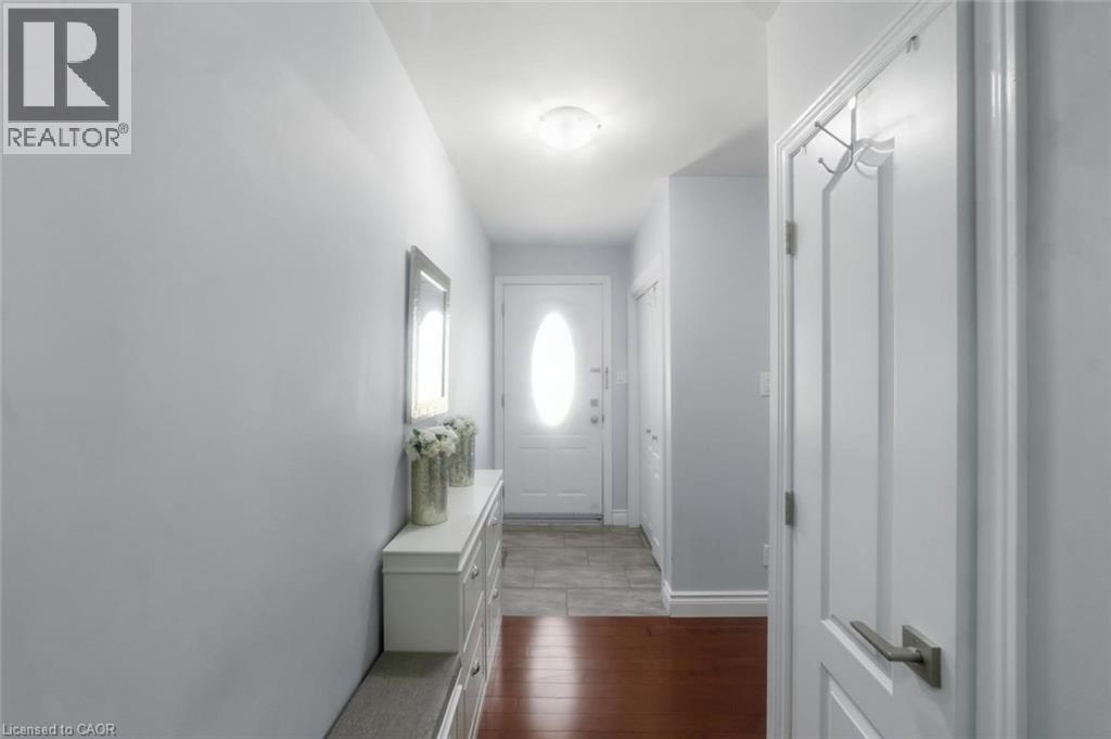 Entryway featuring a white door with an oval glass insert, a flush mount ceiling light, and light gray wall paint - 158 Plymouth Road, Kitchener, ON - Indoor Photo Showing Other Room