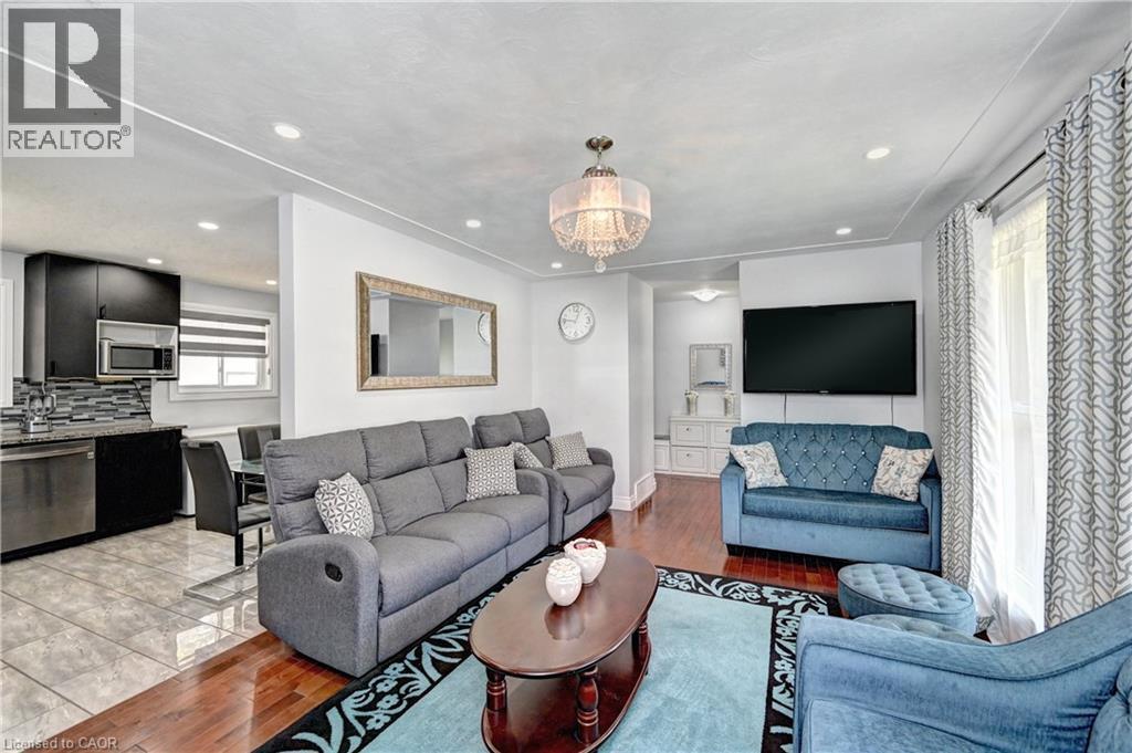 Combined living space with recessed lighting and a decorative chandelier - 158 Plymouth Road, Kitchener, ON