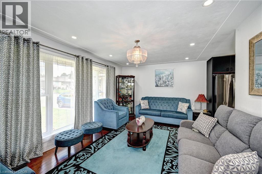Living area featuring wood-finish flooring and recessed ceiling lighting - 158 Plymouth Road, Kitchener, ON