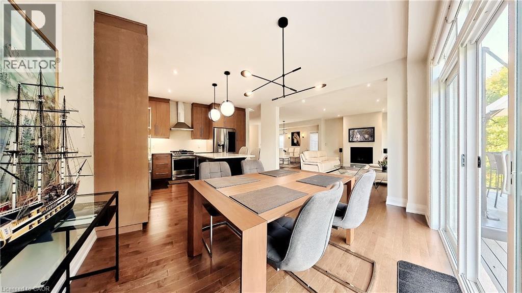 Open-concept main living area with wood-finish flooring throughout - 63 Ian Ormston Drive, Kitchener, ON - Indoor Photo Showing Dining Room
