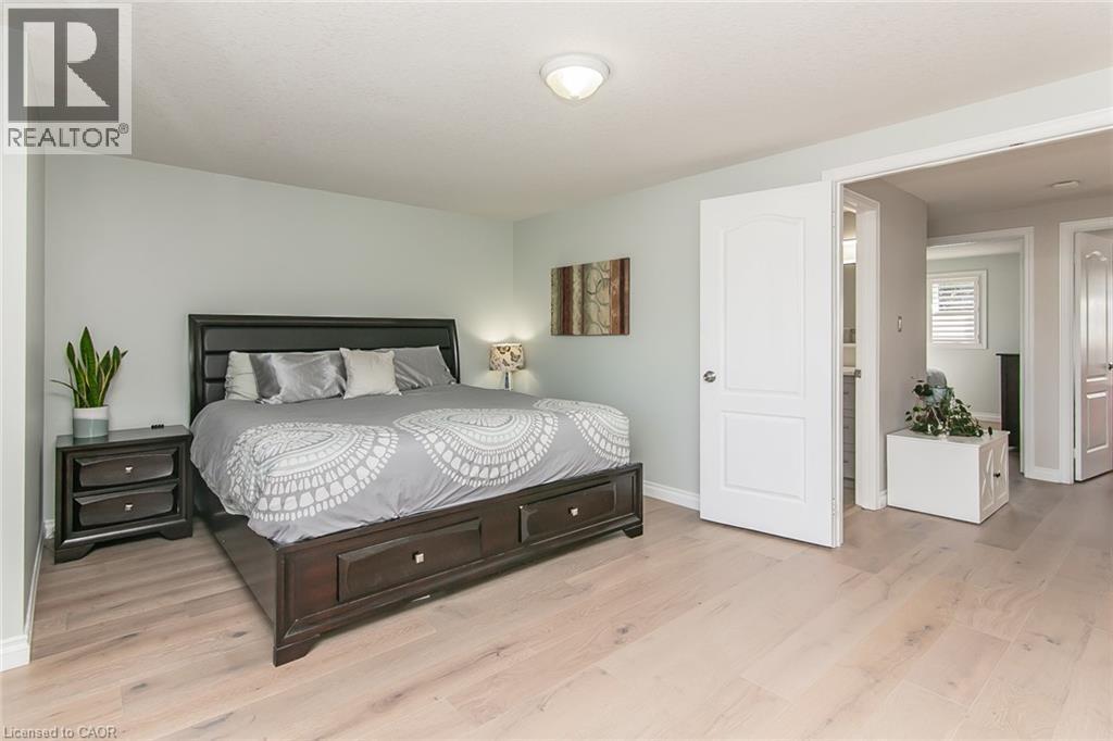 Light wood-finish flooring complements the pastel wall color - 529 Chesapeake Crescent, Waterloo, ON - Indoor Photo Showing Bedroom