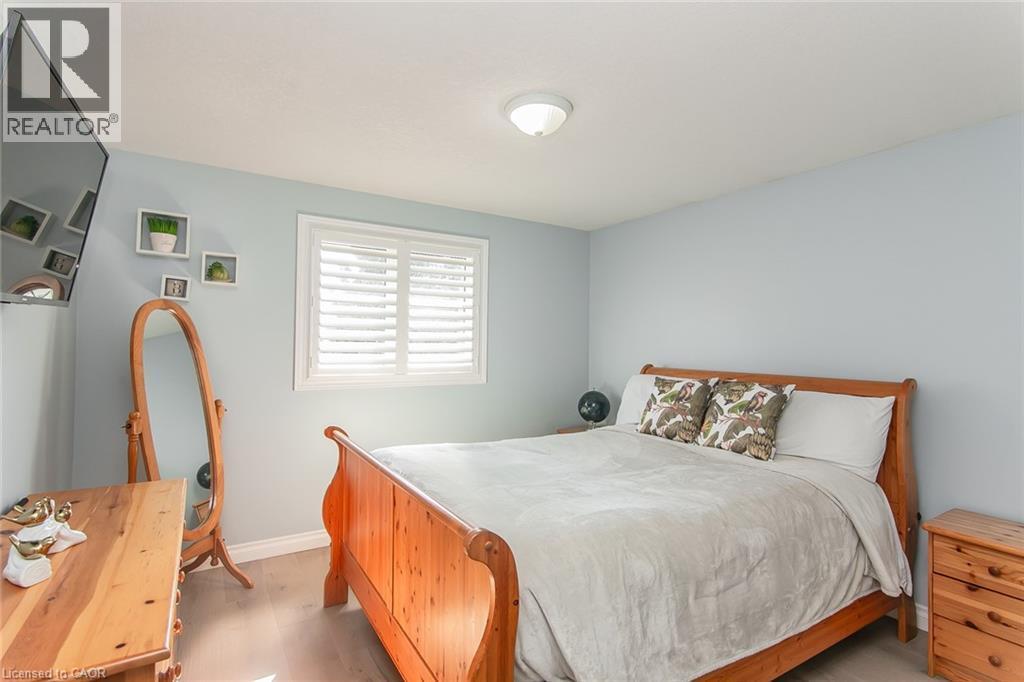 Interior room with light wood-finish flooring and light blue wall paint - 529 Chesapeake Crescent, Waterloo, ON - Indoor Photo Showing Bedroom