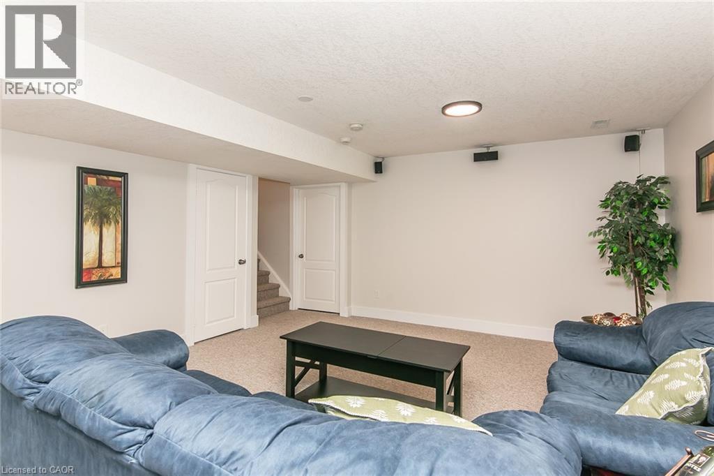 Finished lower level featuring neutral carpeting, recessed lighting, white trim, and a built-in speaker system - 529 Chesapeake Crescent, Waterloo, ON - Indoor