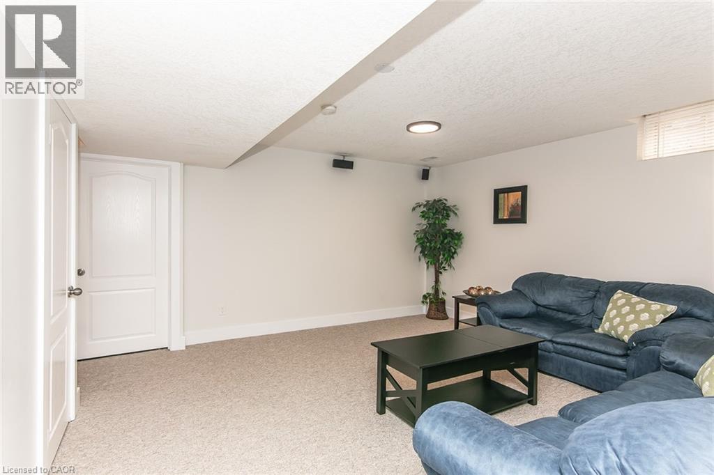 Carpeted room with white walls, a single window, and a built-in ceiling light fixture - 529 Chesapeake Crescent, Waterloo, ON - Indoor Photo Showing Living Room