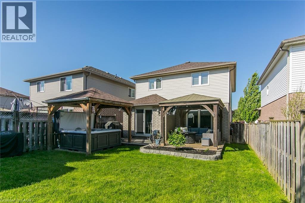 Expansive backyard featuring a lush lawn and two dedicated covered patio areas - 529 Chesapeake Crescent, Waterloo, ON - Outdoor With Deck Patio Veranda