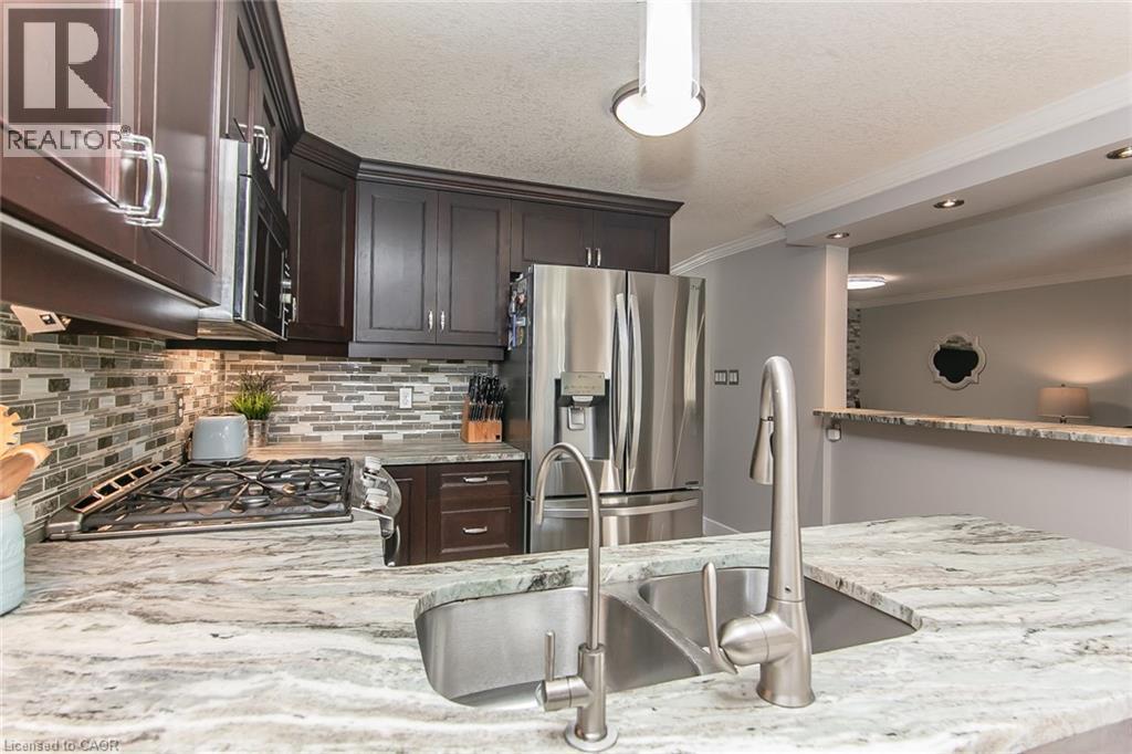 Kitchen island featuring a double basin stainless steel sink with a gooseneck faucet - 529 Chesapeake Crescent, Waterloo, ON - Indoor Photo Showing Kitchen With Double Sink With Upgraded Kitchen